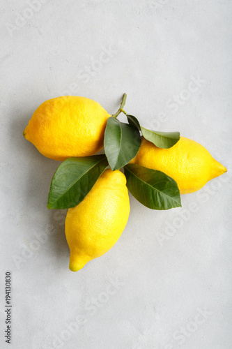 large ripe yellow lemon with leaves. traditional italian fruit Sicilian lemon on a light background top view.