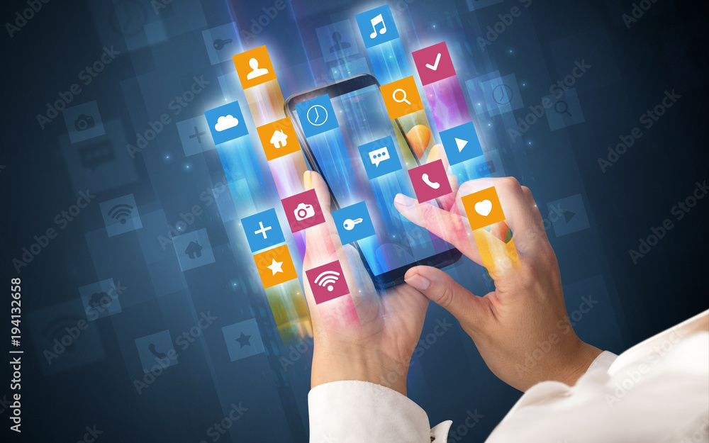 Hand using smartphone with angular app icons Hand using smartphone with angular app icons