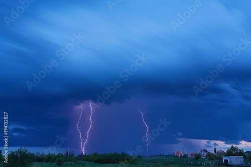 Massive colorful cloud to ground crazy skies lightning bolts hitting the horizon photo