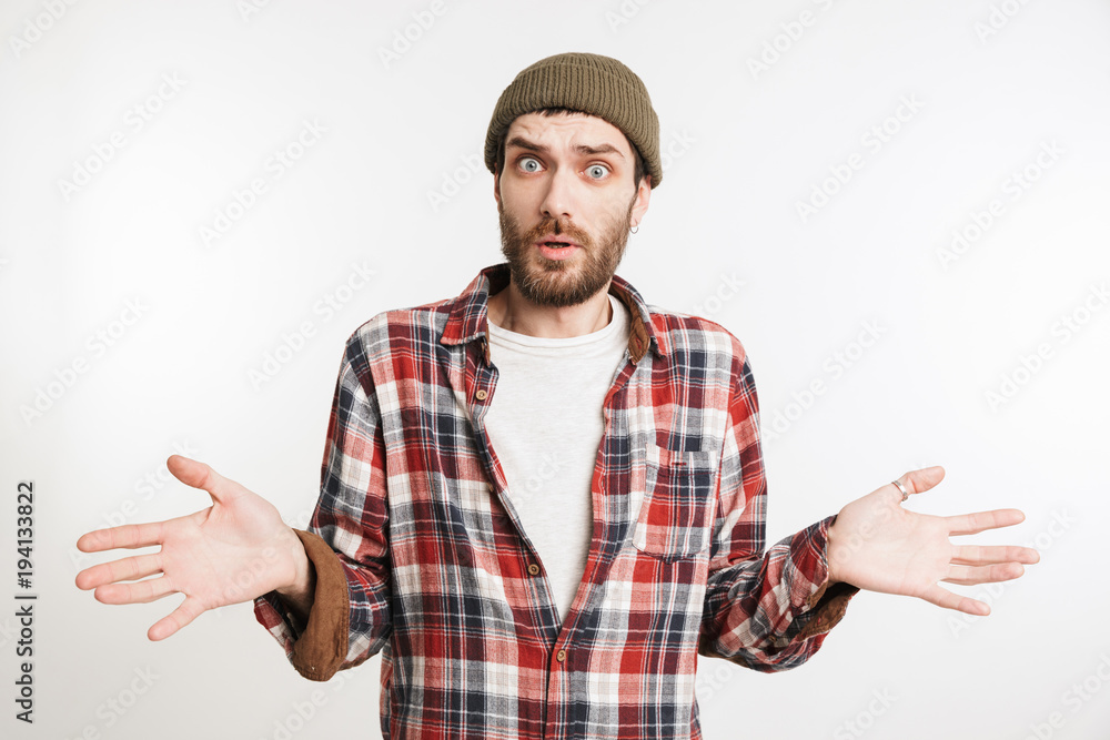 Naklejka premium Portrait of a confused bearded man in plaid shirt