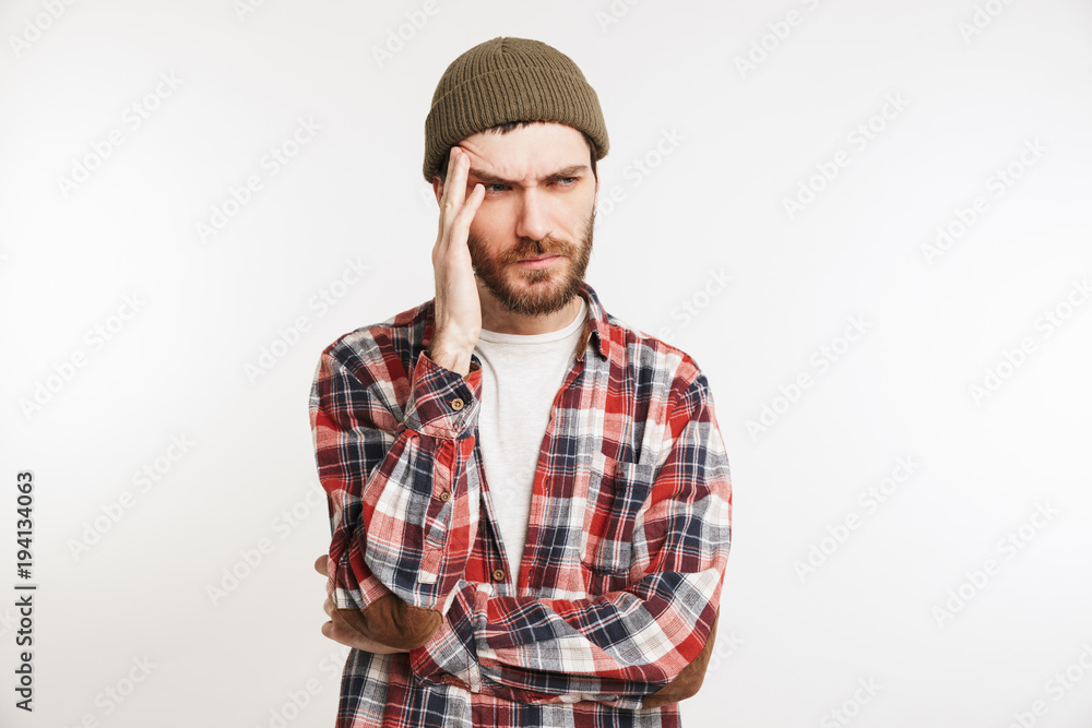 Portrait of a puzzled bearded man in plaid shirt Portrait of a puzzled bearded man in plaid shirt