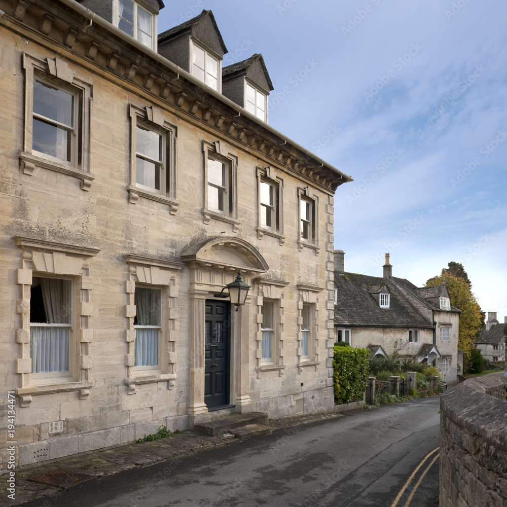 Winter sunshine on the picturesque old Cotswold village streets of Painswick, Gloucestershire, UK