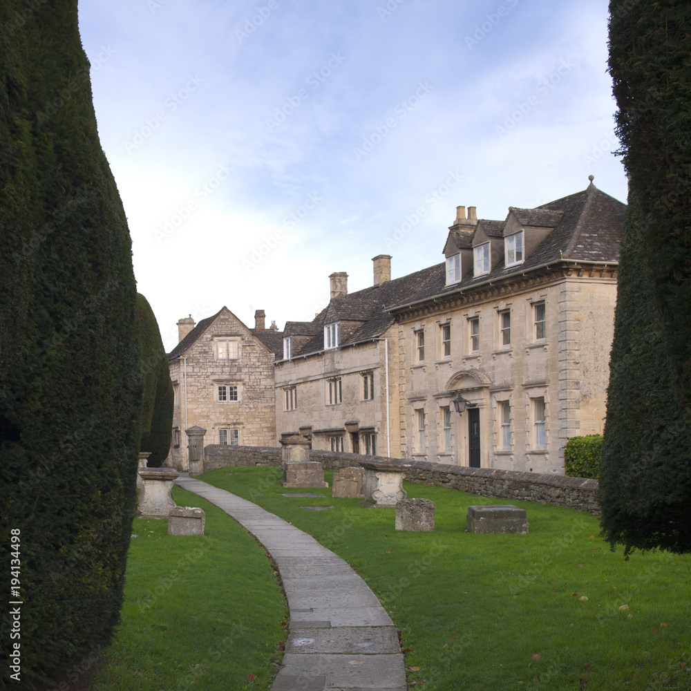 Fototapeta premium Winter sunshine on the picturesque old Cotswold village streets of Painswick, Gloucestershire, UK