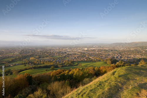 Europe, England, Gloucestershire, Cotswolds, Leckhampton Hill, a couple enjoying the view over Cheltenham in evening sunshine