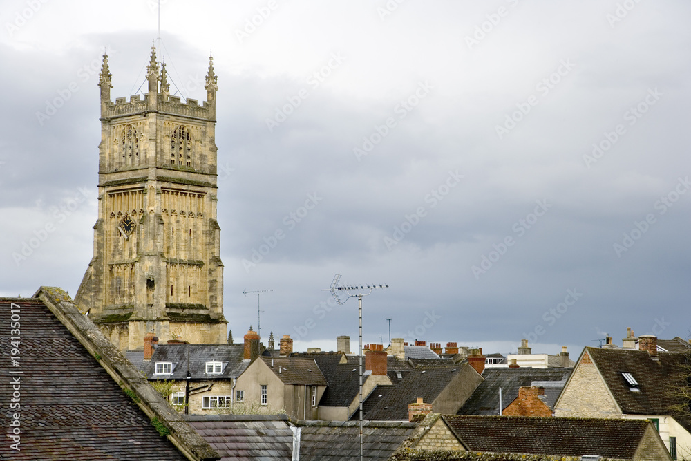 England, Cotswolds, Gloucestershire, view over the old rooftops of Cirencester to the historic Abbey Church