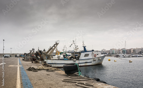 Photograph of a fishing port on a cloudy day. T