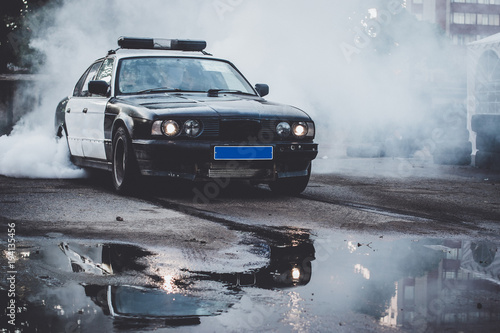 Police car on drift racing motorsport. German driftcar burning tires on asphalt in drift-show. Speed, drive and active sport © Александр Чернышов