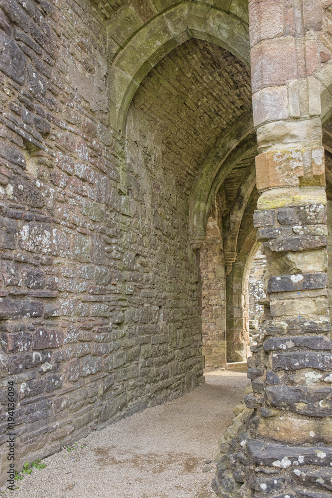 Naklejka premium Tintern Abbey arched corridors
