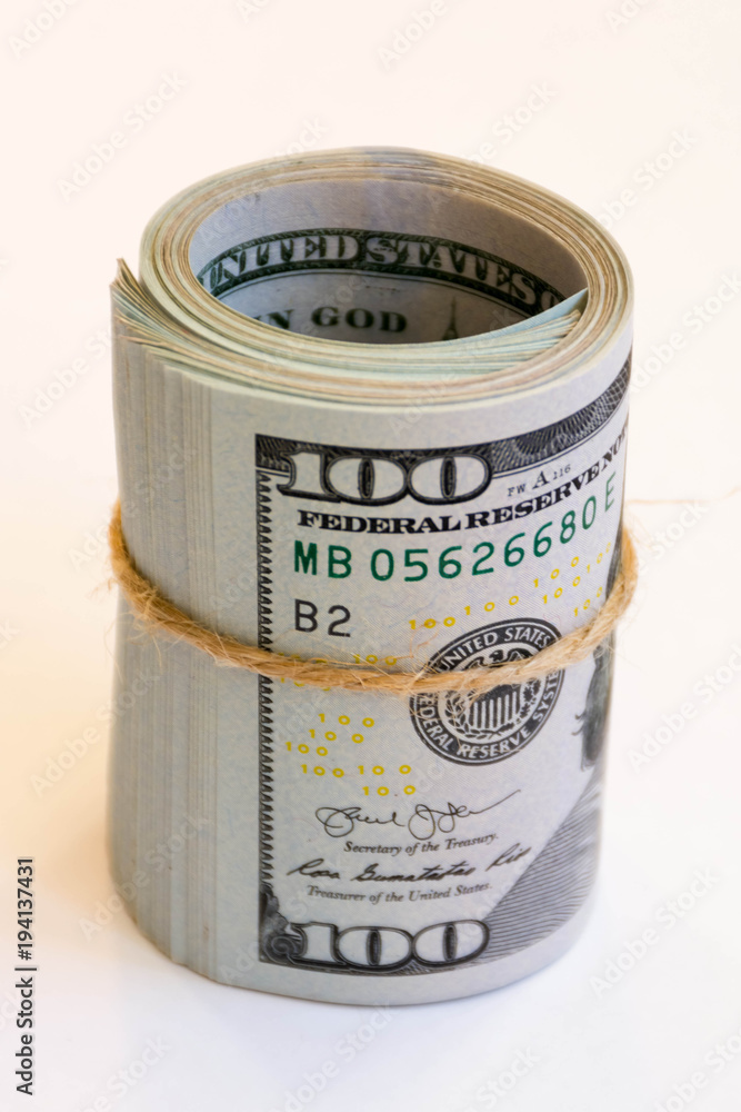 hundred-dollar bills wrapped in a roll and tied with twine hundred-dollar bills wrapped in a roll and tied with twine