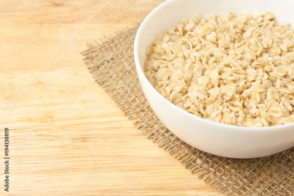 White bowl. Oatmeal porridge. Light background. Healthy food White bowl. Oatmeal porridge. Light background. Healthy food