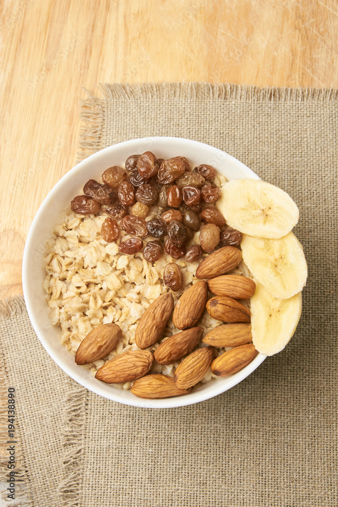White cup. Oatmeal with raisins banana and almonds White cup. Oatmeal with raisins banana and almonds