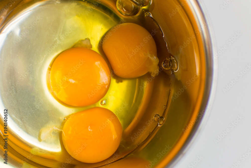 Raw chicken eggs in a metal bowl. Raw chicken eggs in a metal bowl.