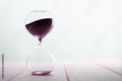 Hourglass with pink sand.