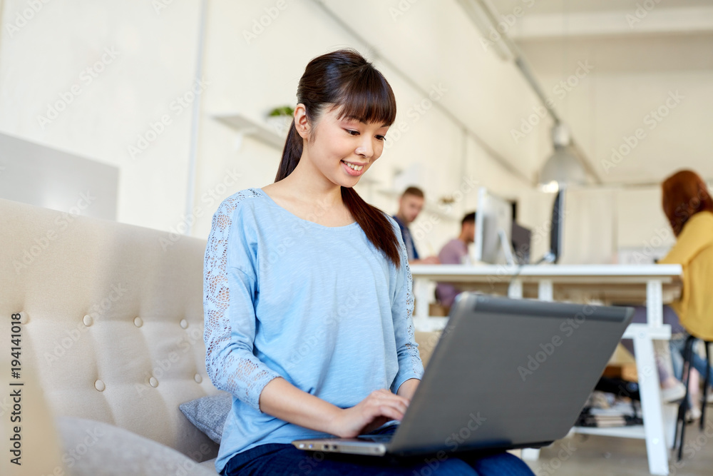 happy asian woman with laptop working at office happy asian woman with laptop working at office