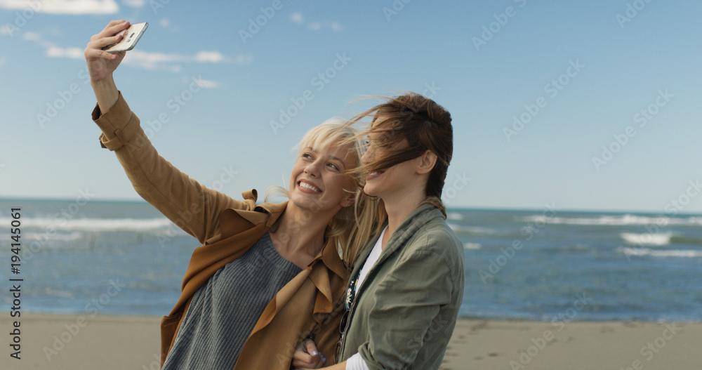 Girls having time and taking selfie on a beach Girls having time and taking selfie on a beach