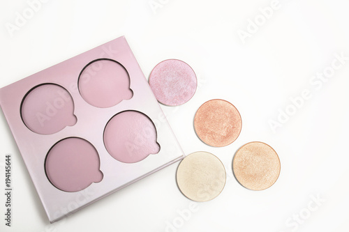 Kit of colorful makeup highlighters on a white background