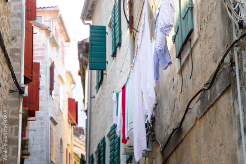 Bed sheets drying in the street, windy hot day. Montenegro, Kotor © Elena Sistaliuk