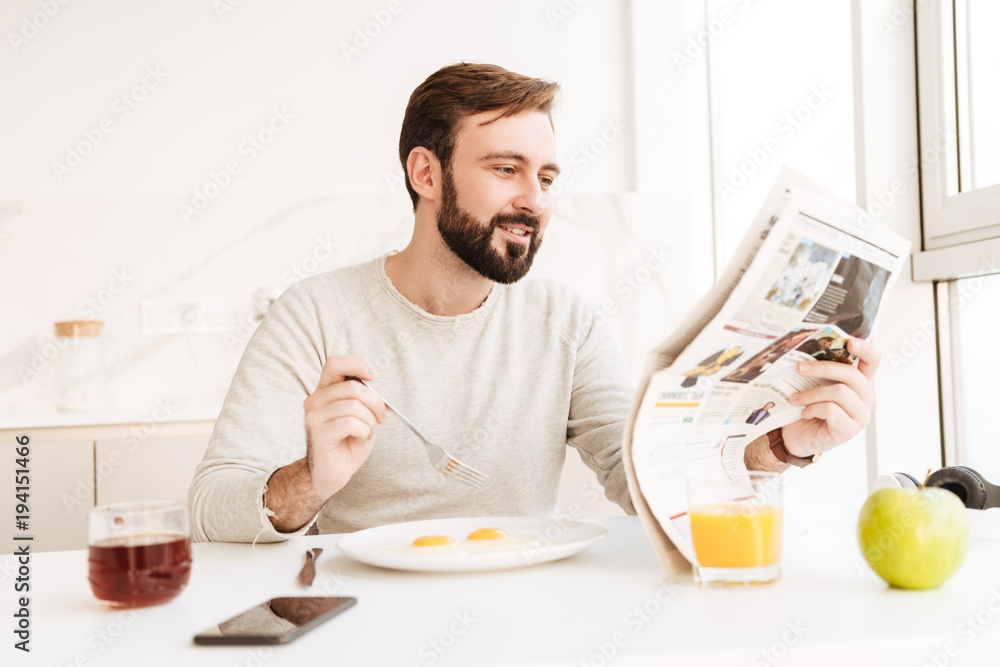 Portrait of a smiling man reading newspaper Portrait of a smiling man reading newspaper