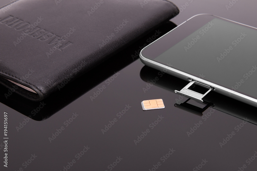 Smartphone and sim card on a dark background Smartphone and sim card on a dark background