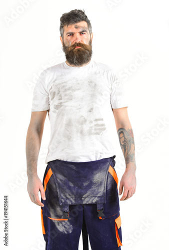 Man with beard in dirty dusty shirt and boilersuit