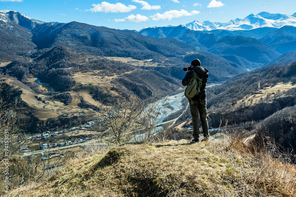 Hiker takes photo of beautiful mountains