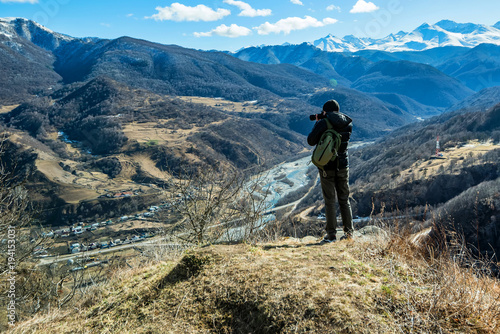 Hiker takes photo of beautiful mountains