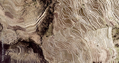 Rice paddies filled with water, creating breathtaking patterns. Aerial view on world's largest and most beautiful Rice Terraces, the Yuanyang Hani Rice Terraces in southeastern Yunnan province, China.