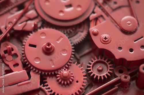 Red gears and cogs macro shot, industrial background 