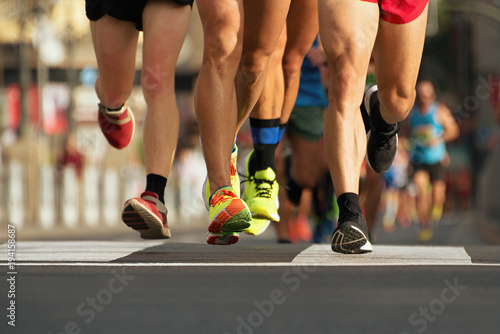 Fototapeta Naklejka Na Ścianę i Meble -  Marathon running race in the light of evening,running on city road detail on legs