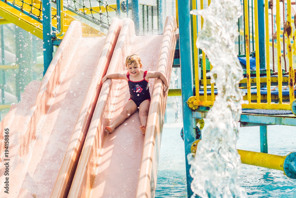 Little Girl having fun in the water park Stock Photo | Adobe Stock