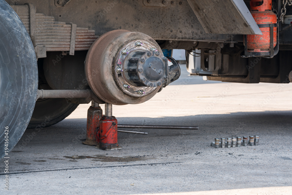 Maintenance a truck wheels hub and bearing with the Jack lifts on