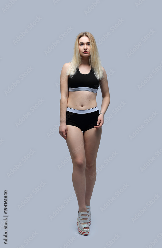 Naklejka premium in full growth.beautiful girl in sport swimsuit.