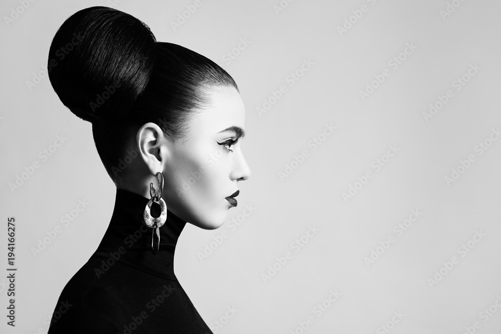 Retro style black and white fashion portrait of elegant female model with  hair bun hairstyle and eyeliner makeup Stock Photo | Adobe Stock