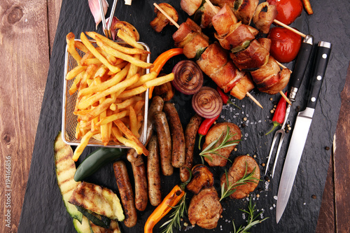 Assorted delicious grilled meat with vegetable and frites on a barbecue