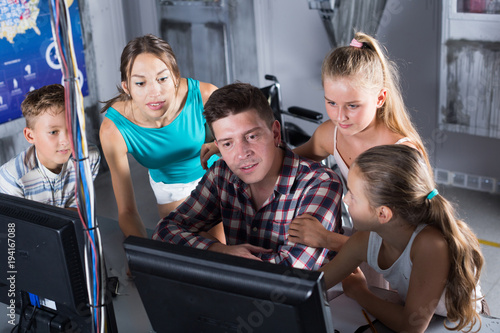 Young family is passing of quest room stylized under laboratory