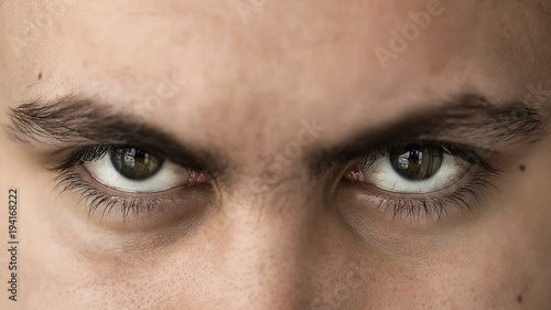Face and eyes of a young handsome man with expressive eyes closeup