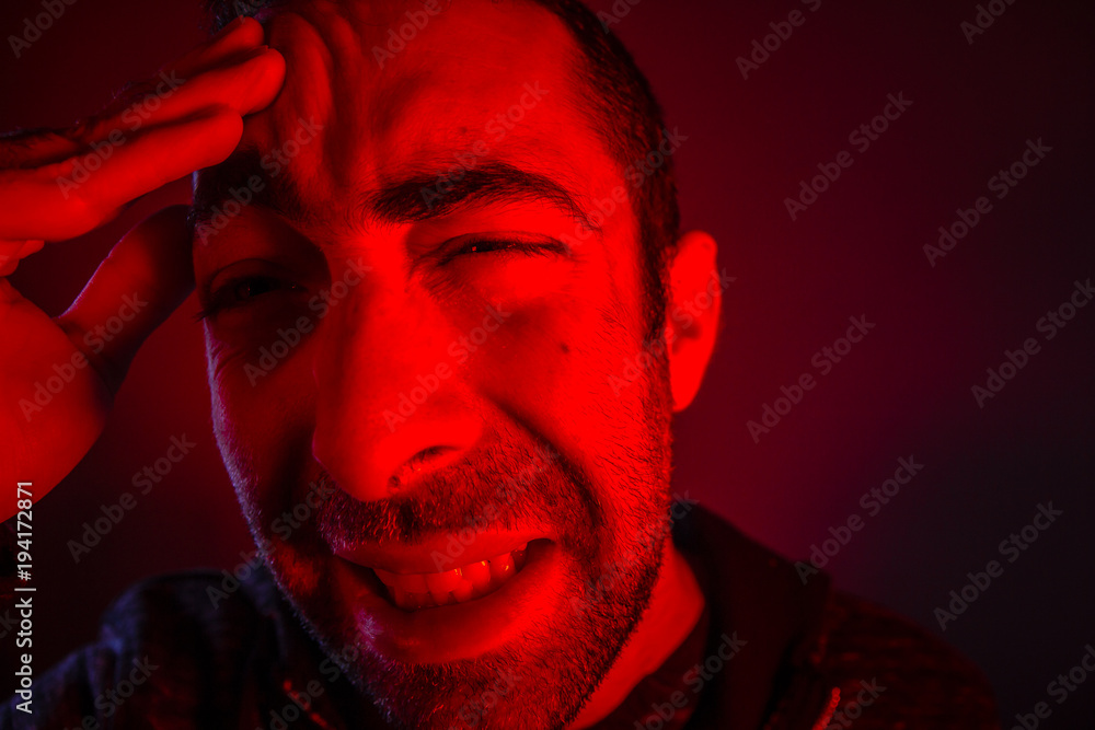 Fototapeta premium Man is suffering in pain from headache