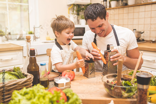 Father is cooking with his son