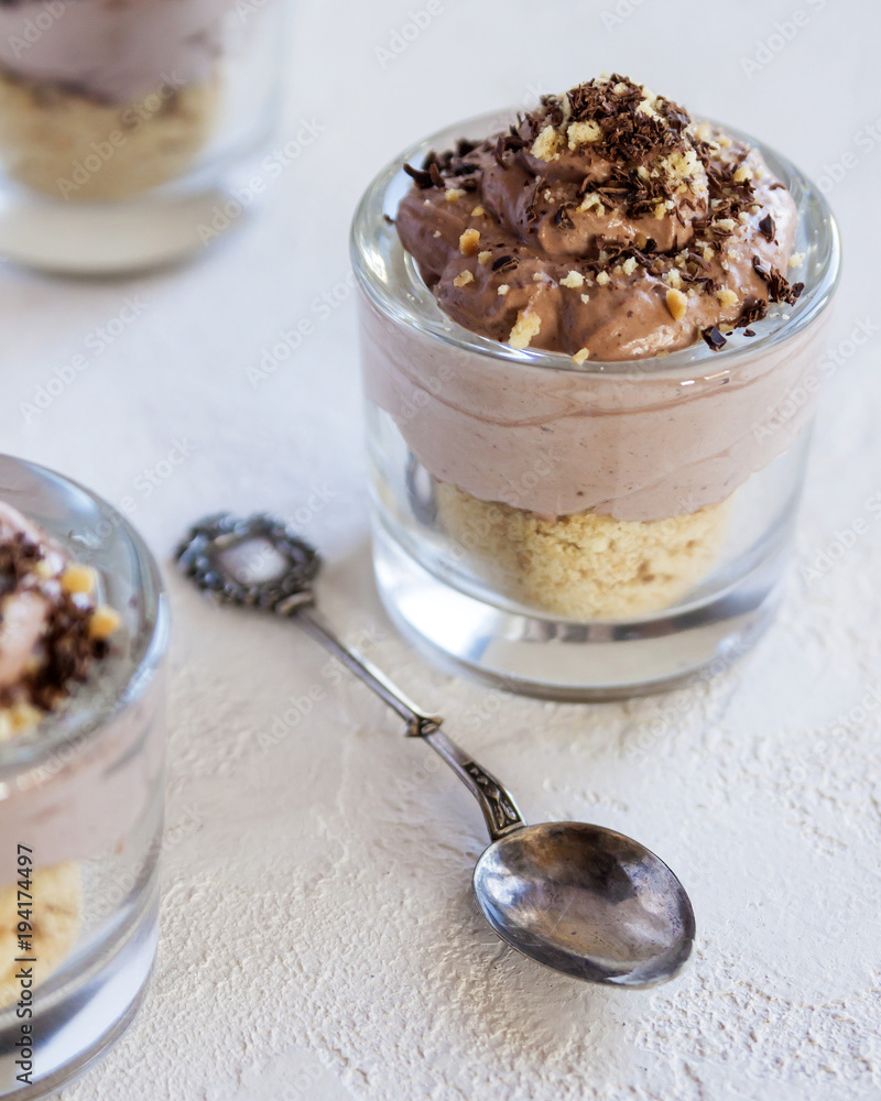 A mouth-watering dessert in the form of ice cream with cookies and chocolate mousse. In glass cups. Selective focus. Close up. A mouth-watering dessert in the form of ice cream with cookies and chocolate mousse. In glass cups. Selective focus. Close up.