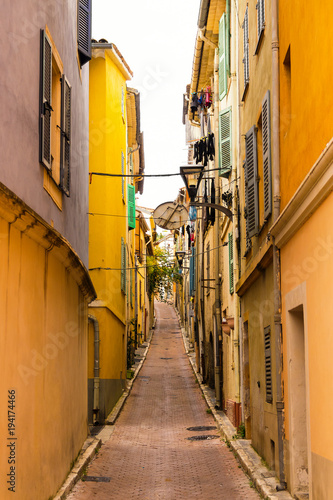 Scene of an empty yellow mediterranean alley in Vallauris, Cote d'Azur