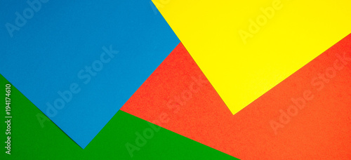 Color papers geometry flat composition background with yellow, green, red and blue tones