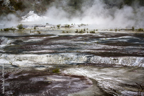 Geothermal activity, terrace and steam rising 