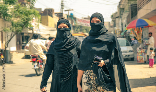 Street life in Pakistan. Pakistani women wearing hijab.