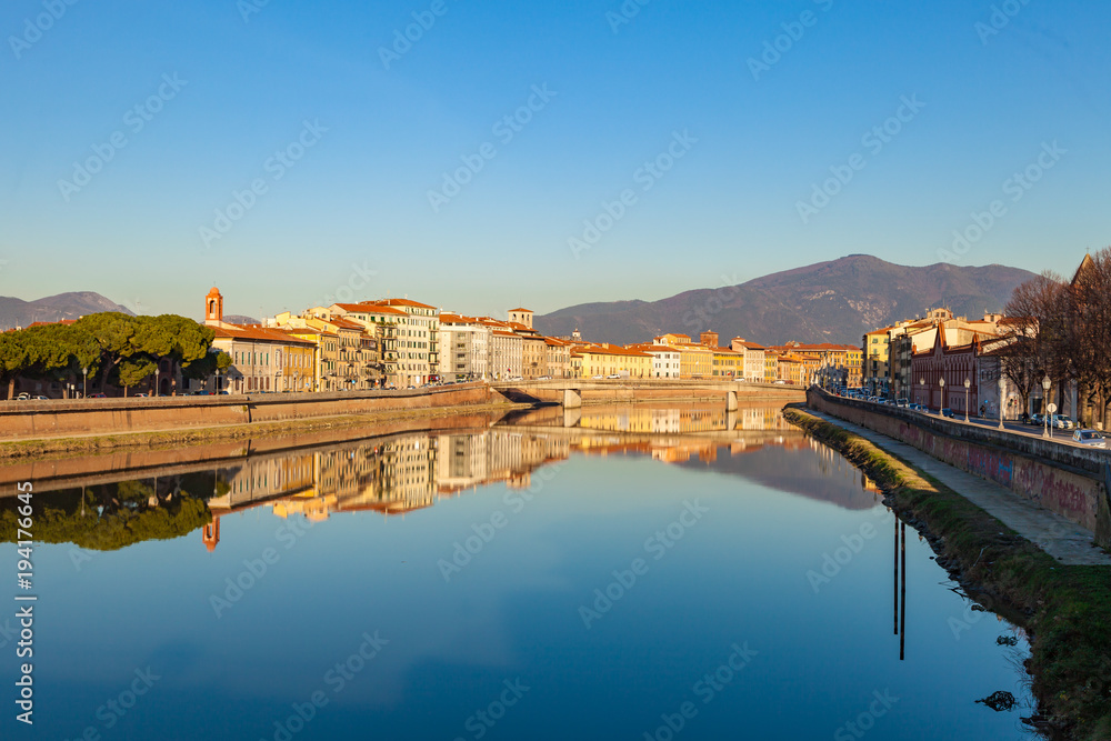Arno river embankment with colorful old houses, view from Ponte della Citadella. Picturesque medieval town of Pisa, Tuscany, Italy.
