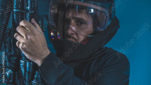 space man with led lights helmet, space suit and gun in the shape of a cannon