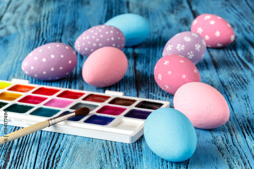 Handmaid blue paint easter egg on table with scarf Handmaid blue paint easter egg on table with scarf