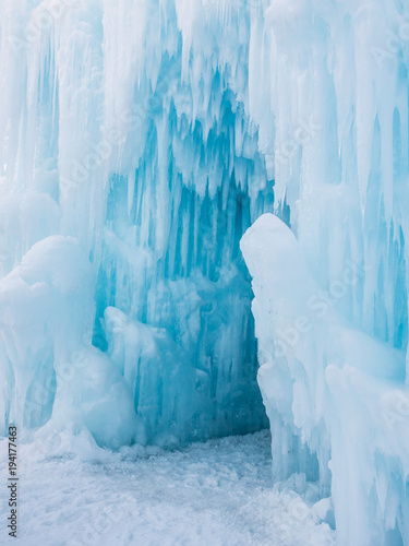 Fotografia, Obraz Winter ice castle caves with frozen icicles at sunset.