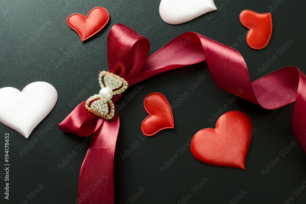 Fototapeta premium bow, ribbon with hearts on a black background