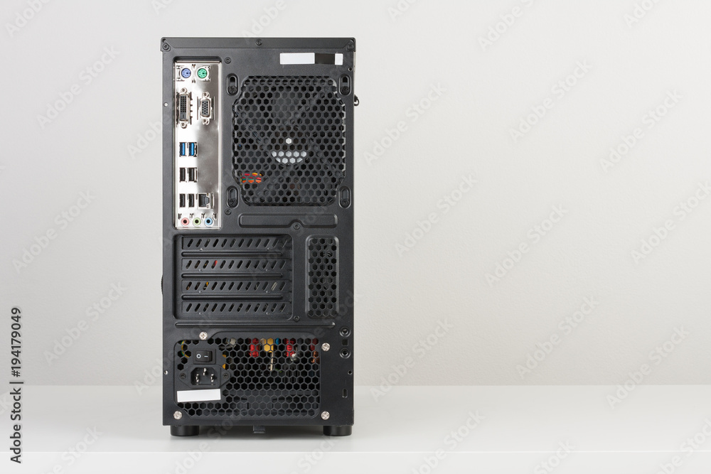 Fototapeta premium Back side of midi tower computer case on white table