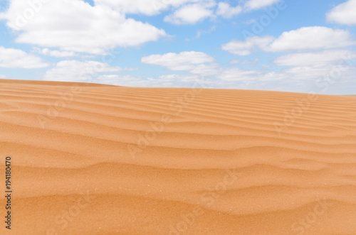 untouched yellow sand dunes and blue sky in the desert between Kalmykia and Astrakhan region